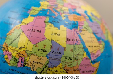 Closeup of a small educational globe showing northern Africa. Picking a world destination on a globe. Selective focus, shallow depth of field.