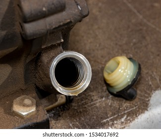 Closeup Of Small Gas Engine On Lawn Mower With Oil Fill Plug Removed Showing Oil Level Inside Of Motor. Concept Of Home Dyi Maintenance And Repair