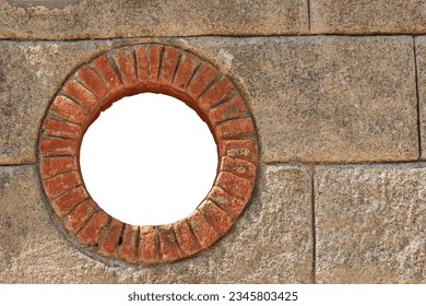Close-up of a small round window with brick frame isolated on white background with copy space. La Spezia province, Liguria, Italy, Europe.