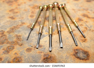 closeup small screwdriver on rusty steel