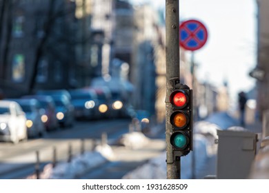 Nahaufnahme eines kleinen Verkehrssemaphors mit rotem Licht vor dem Hintergrund des Stadtverkehrs