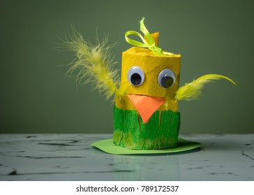 Closeup Of A Small Yellow Chick Made Of Toilet Paper Roll By A Child