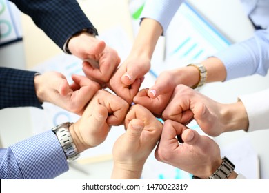 Close-up of smart people performing cooperation gesture to greet presumptive boss or colleagues and show increased level of cohesion and solidarity. Company meeting concept - Shutterstock ID 1470022319