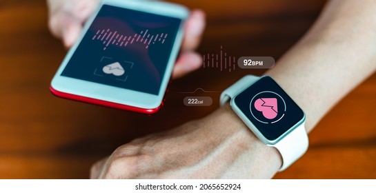 Close-up Of A Smart Watch Health Tracker With The Heart Rate Shown On The Watch And Smartphone Screens. Modern Stylish And Innovation Wearable Device