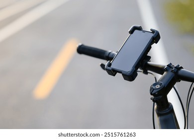 Closeup smartphone in a quick release attached on the handlebar of a bicycle while parking on the roadside