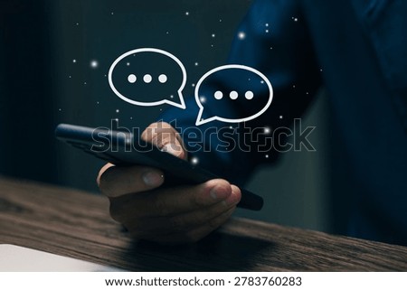 Closeup of smartphone with virtual chat bubbles and messaging interface, representing online communication, social networking, customer support and mobile technology.