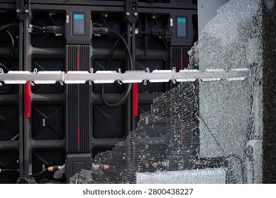 Close-up of  smashed advertising module on a city street. An act of vandalism.