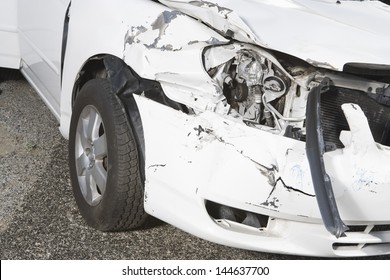 Closeup Of A Smashed Car Headlight On Desert Highway