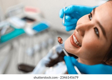  Closeup smile of  asian woman having dental teeth examined dentist check-up  in Clinic. - Powered by Shutterstock