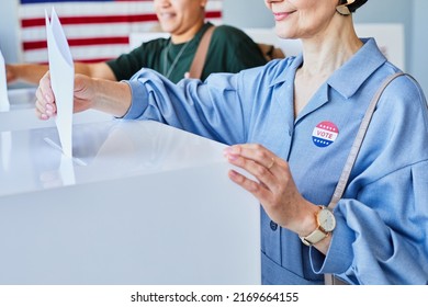 Closeup Of Smiling Adult Woman Voting And Putting Ballot In Bin On Election Day With I Vote Sticker On Shirt, Copy Space