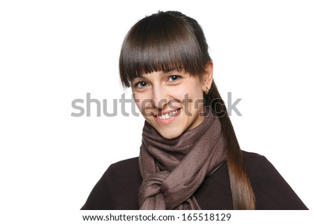 Closeup of smiling brunette female in pullover and scarf, over white background