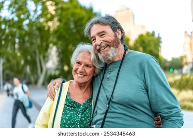 Close-up of smiling caucasian senior couple embracing visiting a city on holidays - Powered by Shutterstock