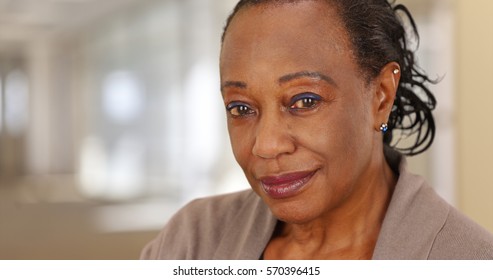 Close-up of a smiling elderly African American woman at work