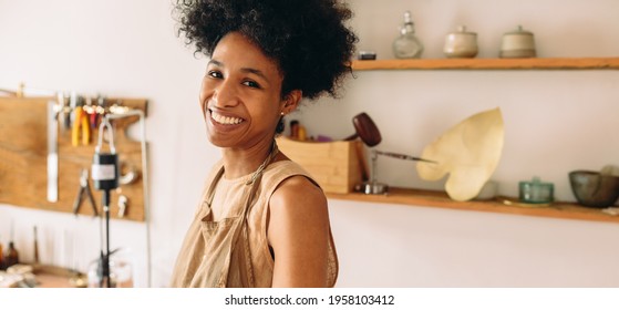 Closeup of smiling female worker in jewelry workshop. Happy woman at jewelry studio. - Powered by Shutterstock