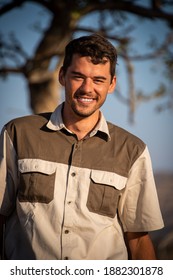 Close-up of smiling safari guide near tree