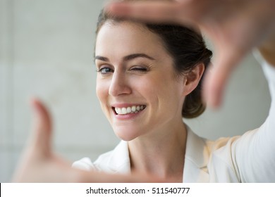 Closeup Of Smiling Woman Making Frame Gesture