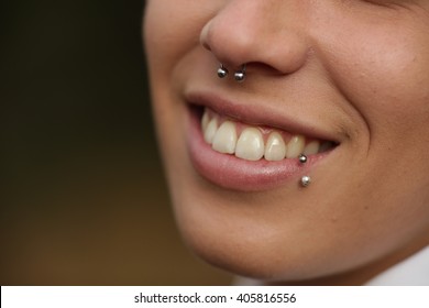 Close-up of smiling woman with piercing