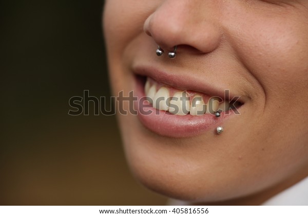 Close-up of smiling woman\
with piercing