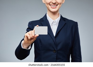 Closeup Of Smiling Young Businesswoman Holding Blank Business Card Mockup And Showing To Camera With Grey Background, Copy Space