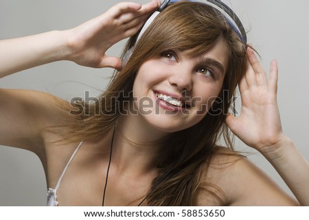 Similar – Blonde woman listening to music with her headphones