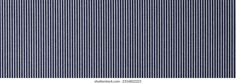 Close-up of smooth black fabric with white stripes textured background for design art work. Striped pattern of cloth backdrop