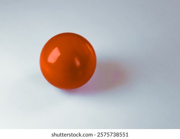 close-up of a smooth solid shiny red glossy ball isolated on a white background. icon symbol lifestyles recreation meaning metaphor graphic art element