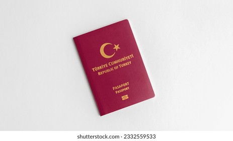 A close-up snapshot featuring a Turkish passport positioned against a clean white backdrop, with the labels "Republic of Turkey" and "Passport" written in Turkish. - Shutterstock ID 2332559533