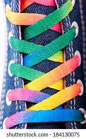 Closeup of a sneaker with colored shoelaces, abstract background