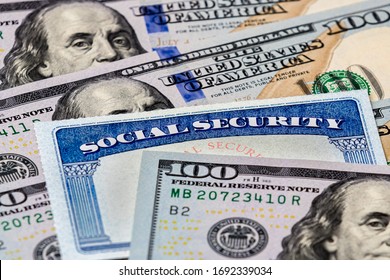 Closeup Of Social Security Benefits Identification Card With 100 Dollar Bills