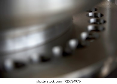 Closeup Soft Focus Of Round Steel Pill Manufacturing Machine Turret