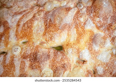 A close-up of soft, golden focaccia bread, rich with olive oil and herbs. Ideal for use in bakery menus, Italian restaurant promotions, food blogs, or Mediterranean-themed content. - Powered by Shutterstock