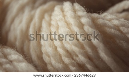 A closeup of a soft yarn of beige thread