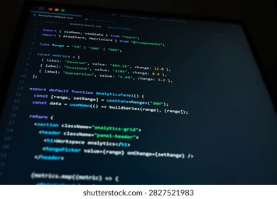 Close-up of software development code on a dark computer screen showing analytics dashboard programming, data metrics and web application interface for modern digital technology and business.