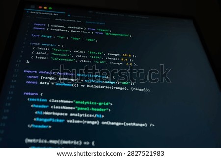Close-up of software development code on a dark computer screen showing analytics dashboard programming, data metrics and web application interface for modern digital technology and business.