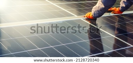 Close-up of solar cell, installing solar cell farm power plant eco technology. Solar cell panels in a photovoltaic power plant. Concept work of sustainable resources hands worker installing solar cell