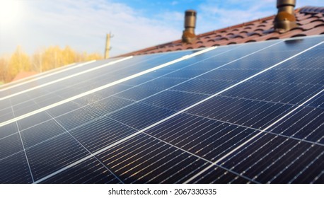 Close-up of Solar energy panel photovoltaic module on the roof of modern house. Closeup of Solar Panels with sunlight - Shutterstock ID 2067330335