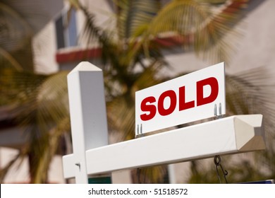 Close-up of Sold Real Estate Sign in Front of House.