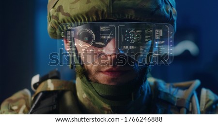 Close-up of a soldier using high-tech sunglasses with holographic display