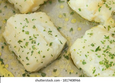 Close-up Of Some Hake Loins In Green Sauce With Parsley And Oil. Healthy Food And Fish.