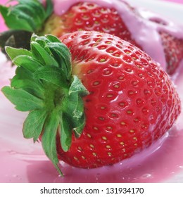 closeup of some strawberries in strawberry yoghurt