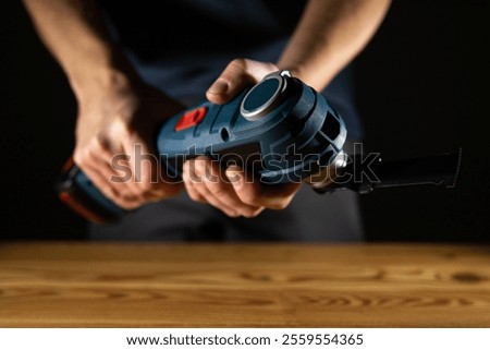 Closeup of someone skillfully using a handheld electric vibro Multi Cutter tool for various DIY tasks and projects