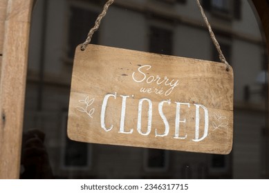 Closeup of sorry we are closed panel in a fashion store entry in the street - Shutterstock ID 2346317715