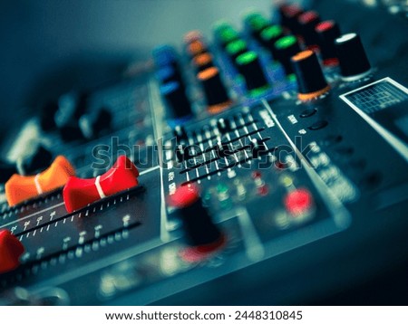 Close-up of sound recording equipment knobs. Mixer control. Music engineer. Backstage controls on an audio mixer, Sound mixer. Professional audio mixing console, buttons, faders and sliders.