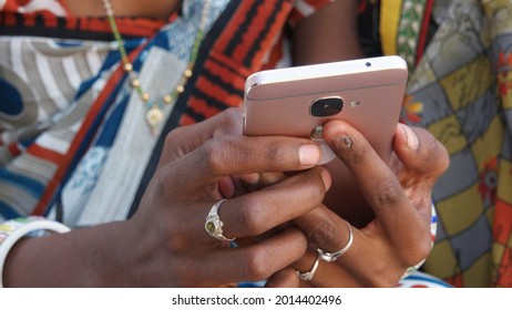 A Closeup Of A South Asian Girl's Hands Holding A Rose Gold Phone While Wearing Traditional Clothi