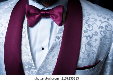 A Closeup Of A South Asian Groom Wearing A Clean White Wedding Suit