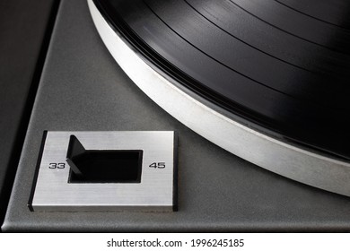 Close-up of speed rotation switch set to 33 RPM on vintage turntable vinyl record player