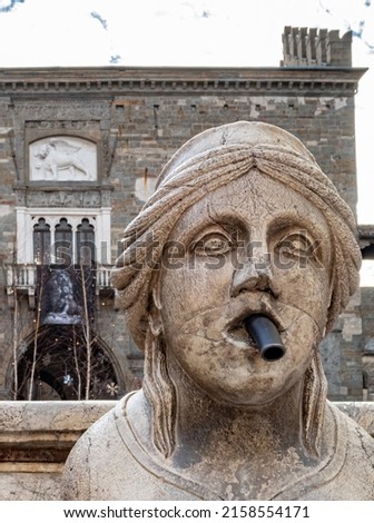 A closeup of the sphinx sculpture of the Contarini Fountain in the old square in Bergamo, Italy