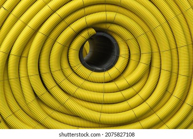 Closeup Of Spool Of Rolled Yellow Farm Drainage Tile In Landscape Orientation