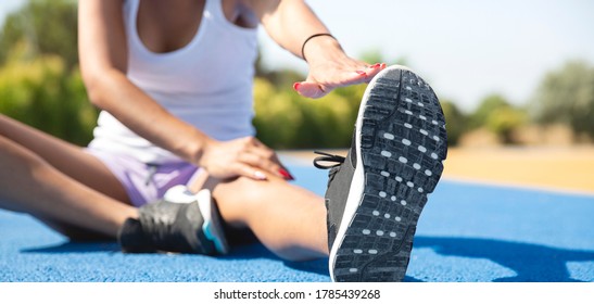 Close-up of a sportswoman stretching outdoors before playing sports. Selective focus. Concept of sport and healthy life.