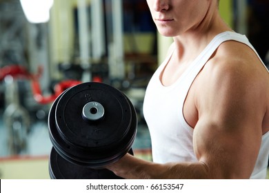 Close-up of sporty man training in gym with barbell - Powered by Shutterstock